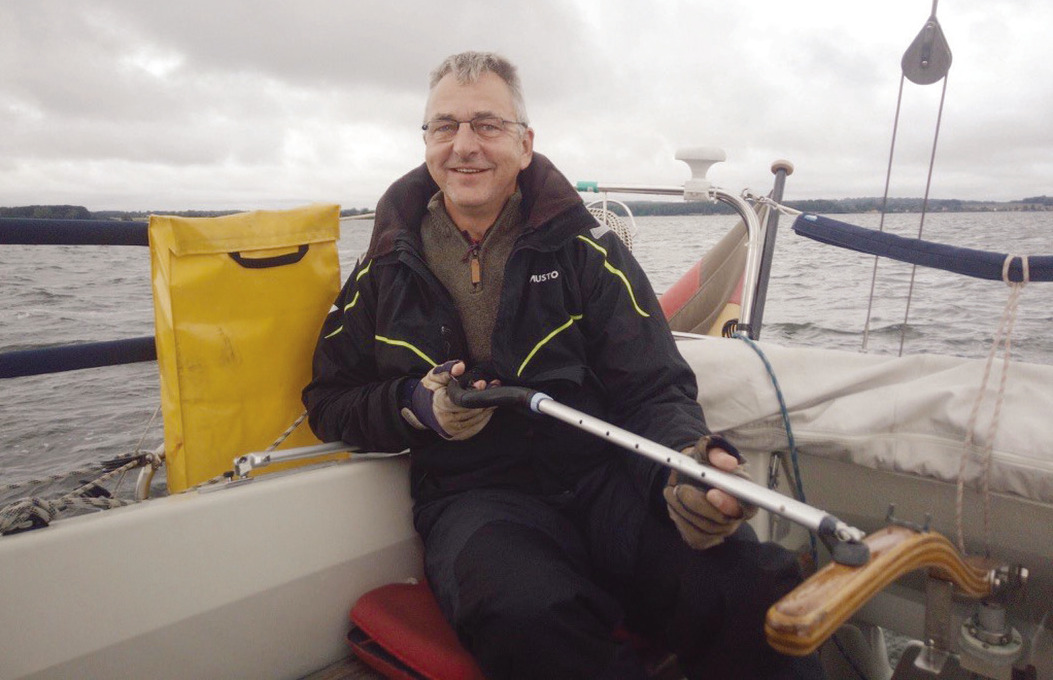 Uwe Bornscheuer on his sailboat Luna near Greifswald on the Baltic Sea. He is using the equivalent of a selfie stick to manipulate the tiller more comfortably.