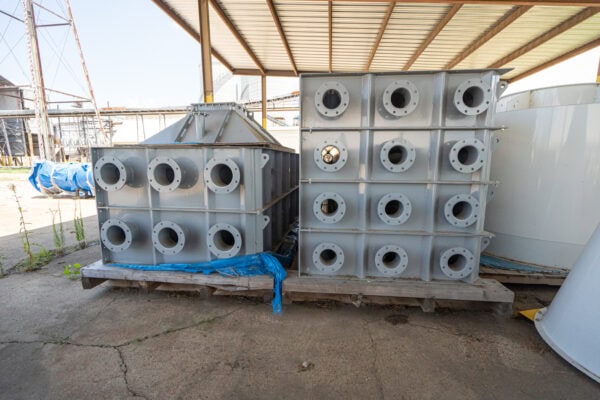A group of metal boxes sitting on a pallet.