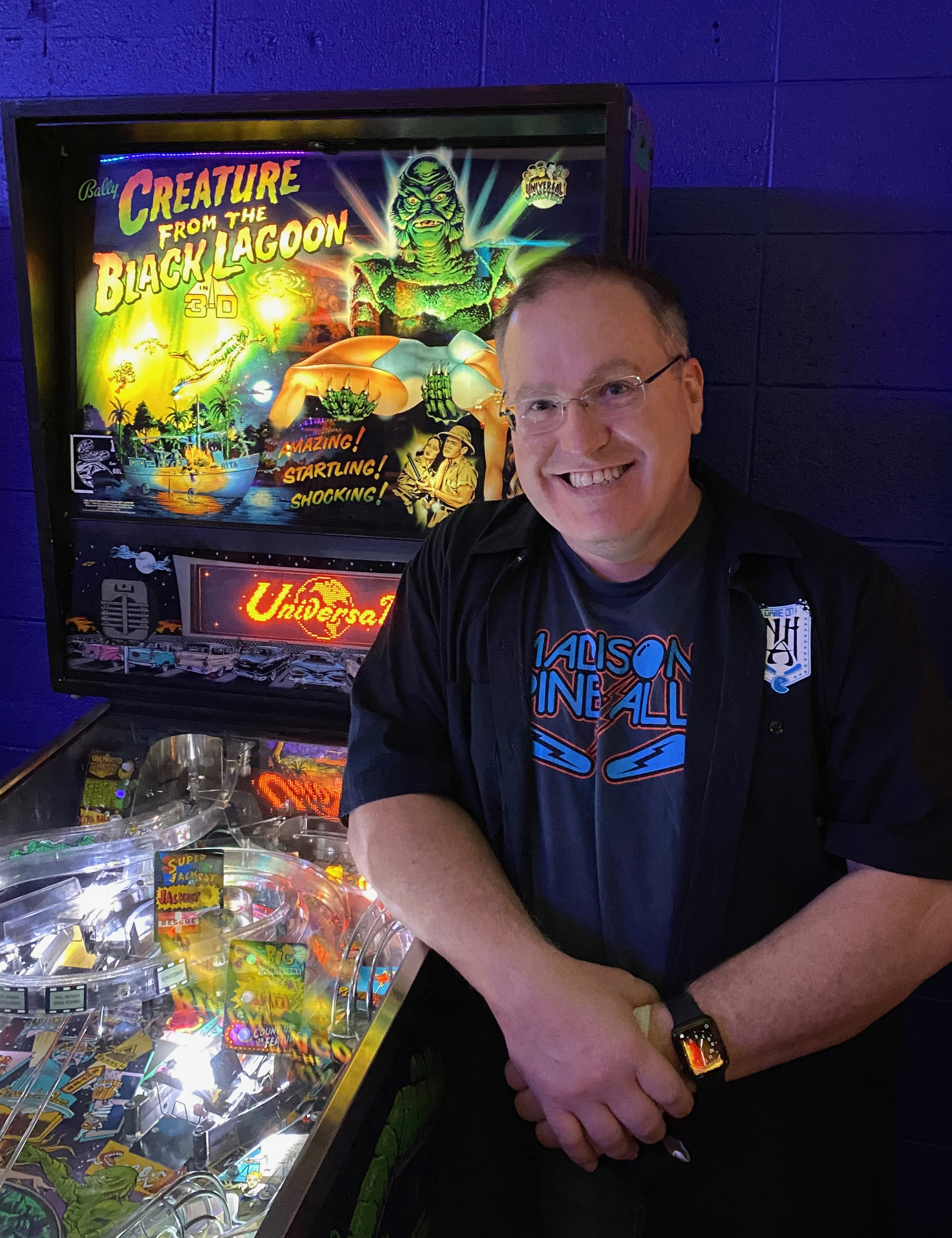Mike Williams next to a pinball machine